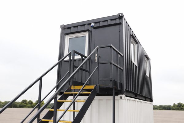Bespoke steel staircase and landing providing access to upper level container office